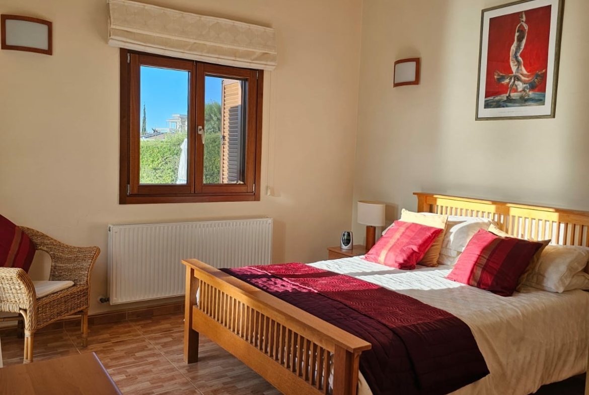 Hauson Realty - Cyprus Real Estate Agents A bedroom with wooden floors and a bed.