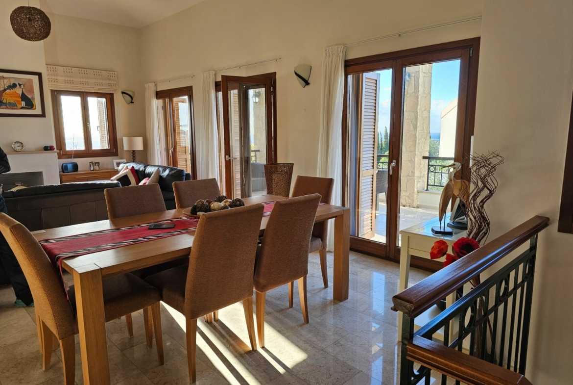 Hauson Realty - Cyprus Real Estate Agents A living room with a dining table and chairs.