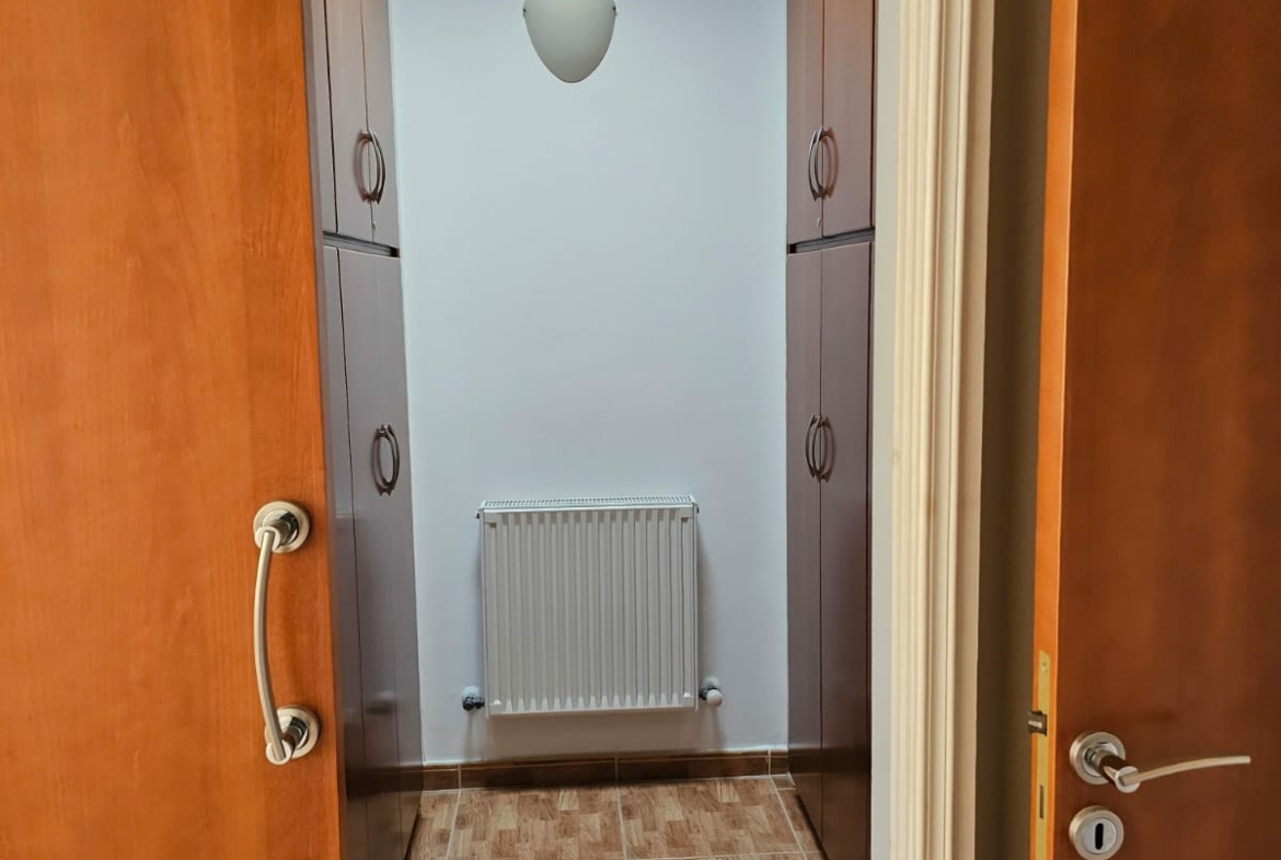 Hauson Realty - Cyprus Real Estate Agents A hallway with wooden doors and a radiator.