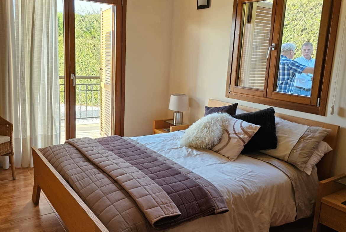 Hauson Realty - Cyprus Real Estate Agents A bedroom with wooden floors and a bed.