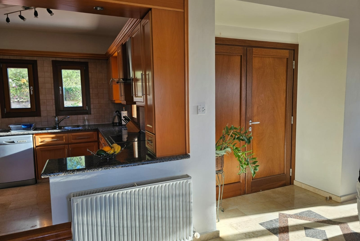 Hauson Realty - Cyprus Real Estate Agents A kitchen with wooden cabinets and a radiator.
