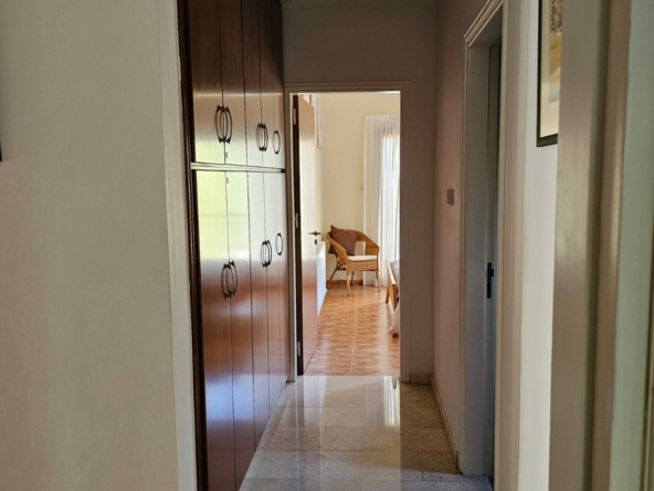 Hauson Realty - Cyprus Real Estate Agents A hallway with a wooden floor and wooden cabinets.