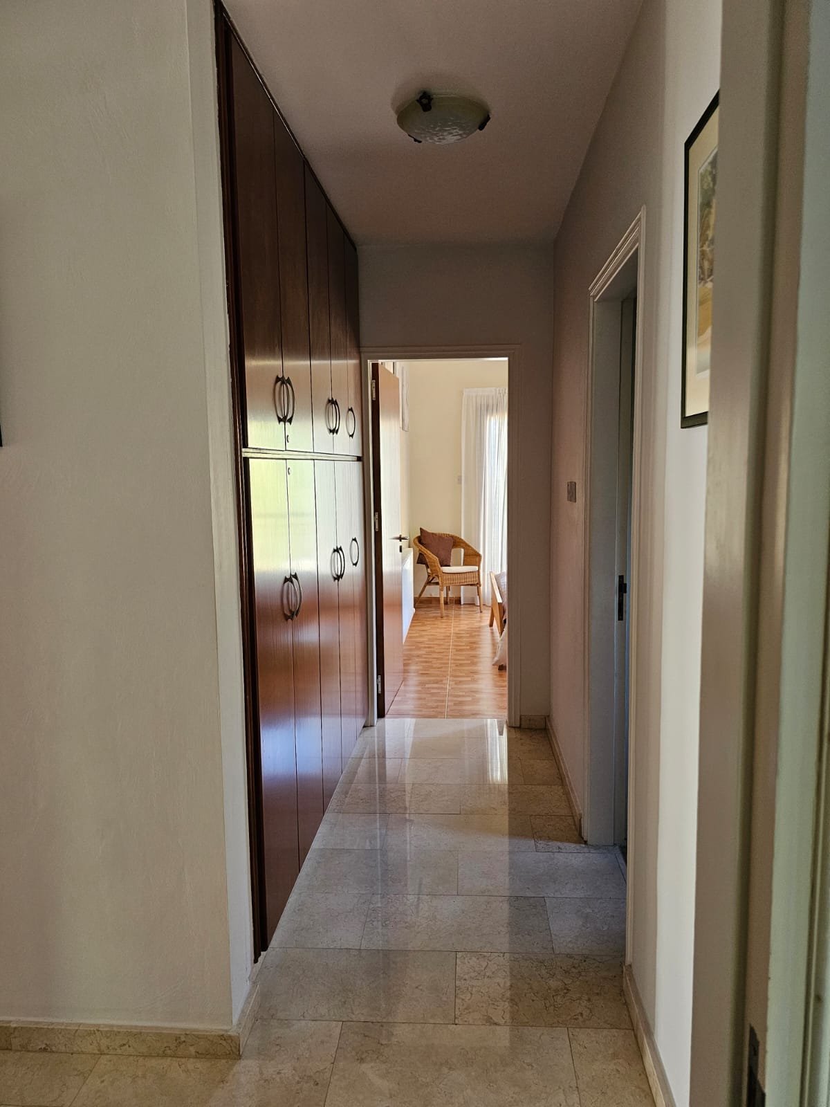 Hauson Realty - Cyprus Real Estate Agents A hallway with a wooden floor and wooden cabinets.