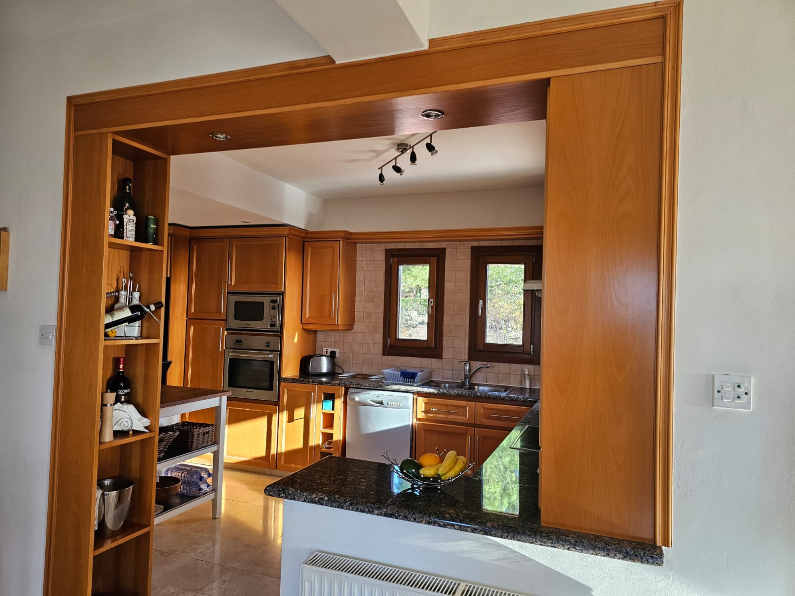 Hauson Realty - Cyprus Real Estate Agents A kitchen with wooden cabinets and counter tops.