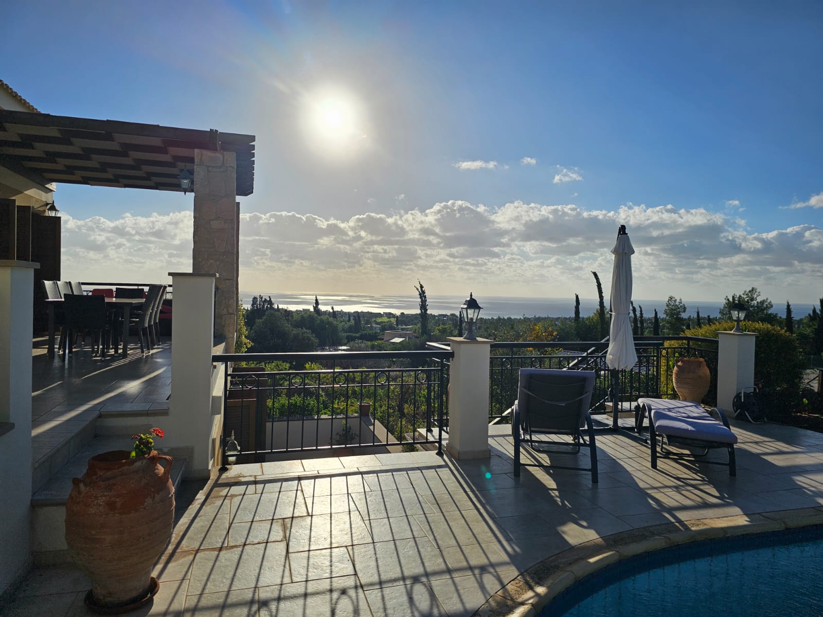 Hauson Realty - Cyprus Real Estate Agents A house with a pool and sun deck overlooking the sea.