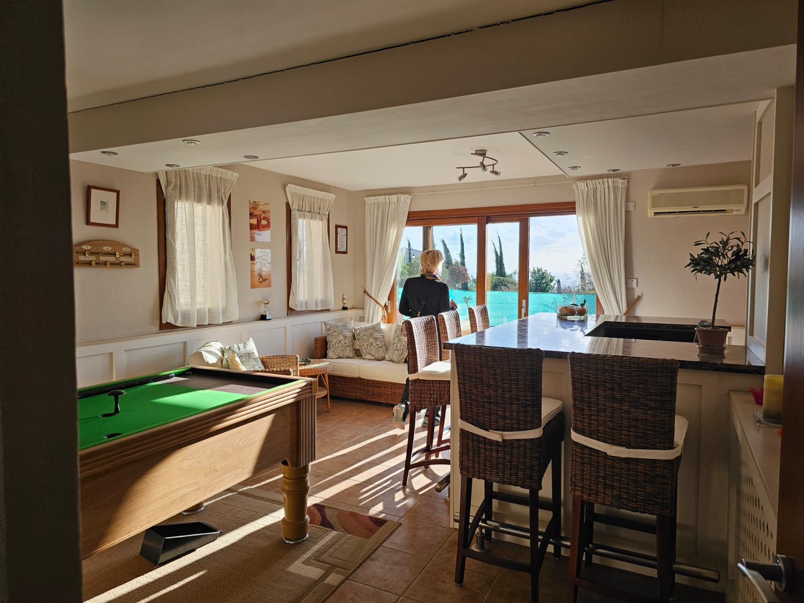 Hauson Realty - Cyprus Real Estate Agents A living room with a pool table and bar stools.